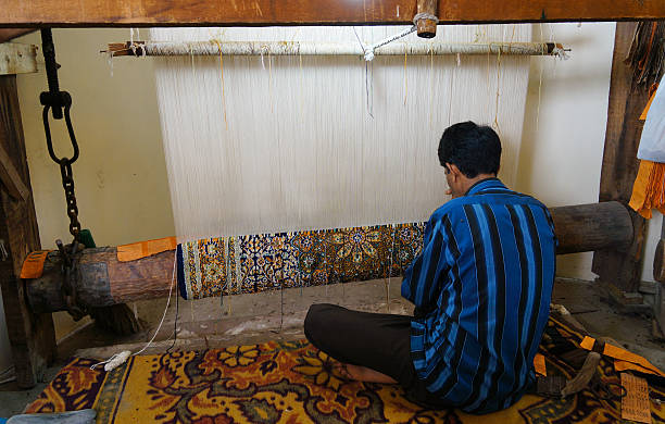 Kashmiri artisan working on a traditional handloom, continuing the centuries-old heritage of carpet weaving in Kashmir, famous worldwide for its intricate patterns, natural dyes, and cultural legacy that dates back to the Mughal era.
