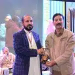 President of Human Rights Council of Pakistan (AJK), Ishtiaq Ahmed Qureshi, presenting an award to Shoukat Nawaz Mir, member of the Joint Awami Action Committee, for his effective and consistent advocacy for the fundamental human rights of the Kashmiri people.