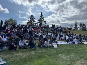 Kashmiri diaspora in Canada rallies with signs reading “Stop Killing Kashmiris” and waving white flags for peace.