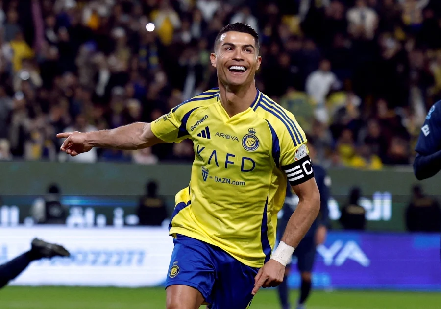 Cristiano Ronaldo celebrating a goal, wearing Al Nassr jersey, symbolising his record $275 million earnings Cristiano Ronaldo celebrating a goal, wearing Al Nassr jersey, symbolising his record $275 million earnings