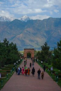 a group of people walking down a walkway in Srinagar, Jammu Kashmir