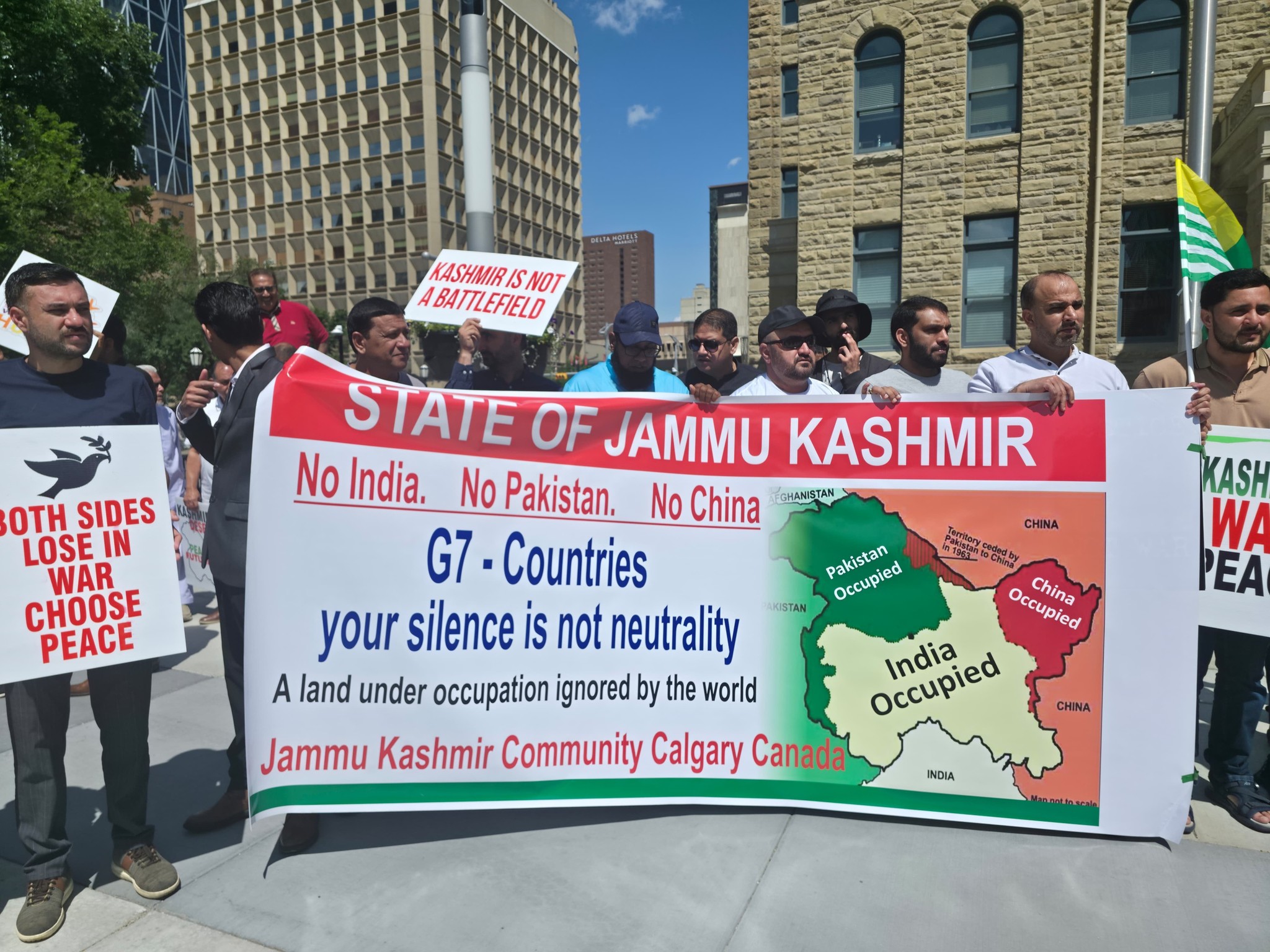 Kashmiri community protesters stand holding a banner that reads: 'No India, No Pakistan, No China – G7, Your Silence is Not Neutrality' during a peaceful demonstration outside Calgary City Hall amid the G7 Summit 2025.