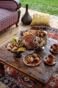 Traditional Kashmiri dishes including Rogan Josh, Gushtaba, Dum Aloo, and Kahwa tea served in a authentic Kashmiri setting, showcasing the rich culinary heritage of Jammu and Kashmir.