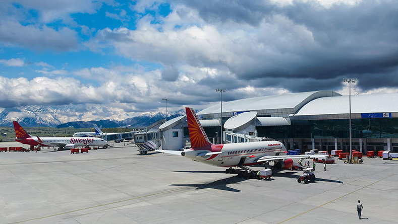 “Exterior view of Srinagar International Airport terminal in Kashmir, showing current architecture and surrounding mountains