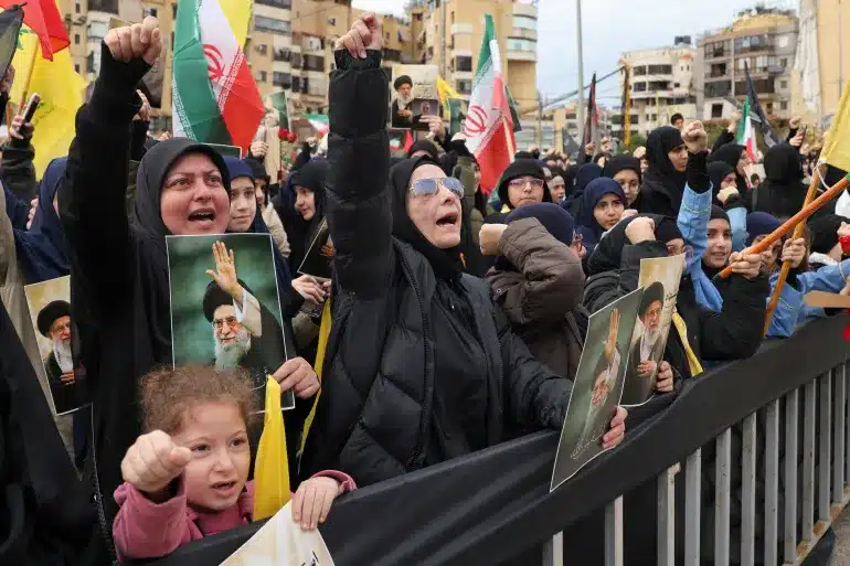 Mourners chant slogans during a rally by supporters of Lebanon’s Hezbollah movement on Sunday [AFP]