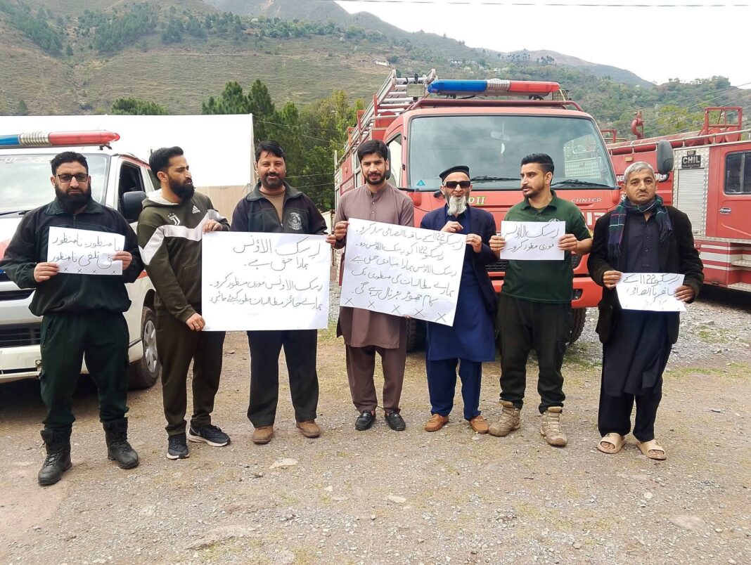 Rescue 1122 employees protest outside the District Emergency Rescue Office in Jhelum Valley demanding risk allowance.